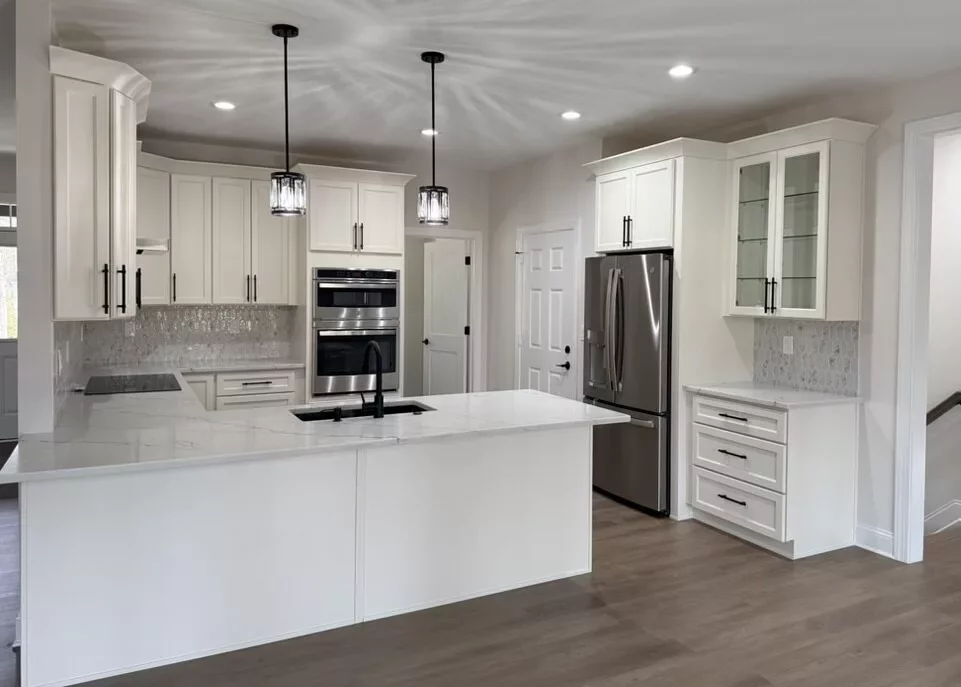 Custom kitchen in Locust Grove, VA with white shaker cabinets, a marble-look quartz island, double wall ovens, and stainless steel appliances
