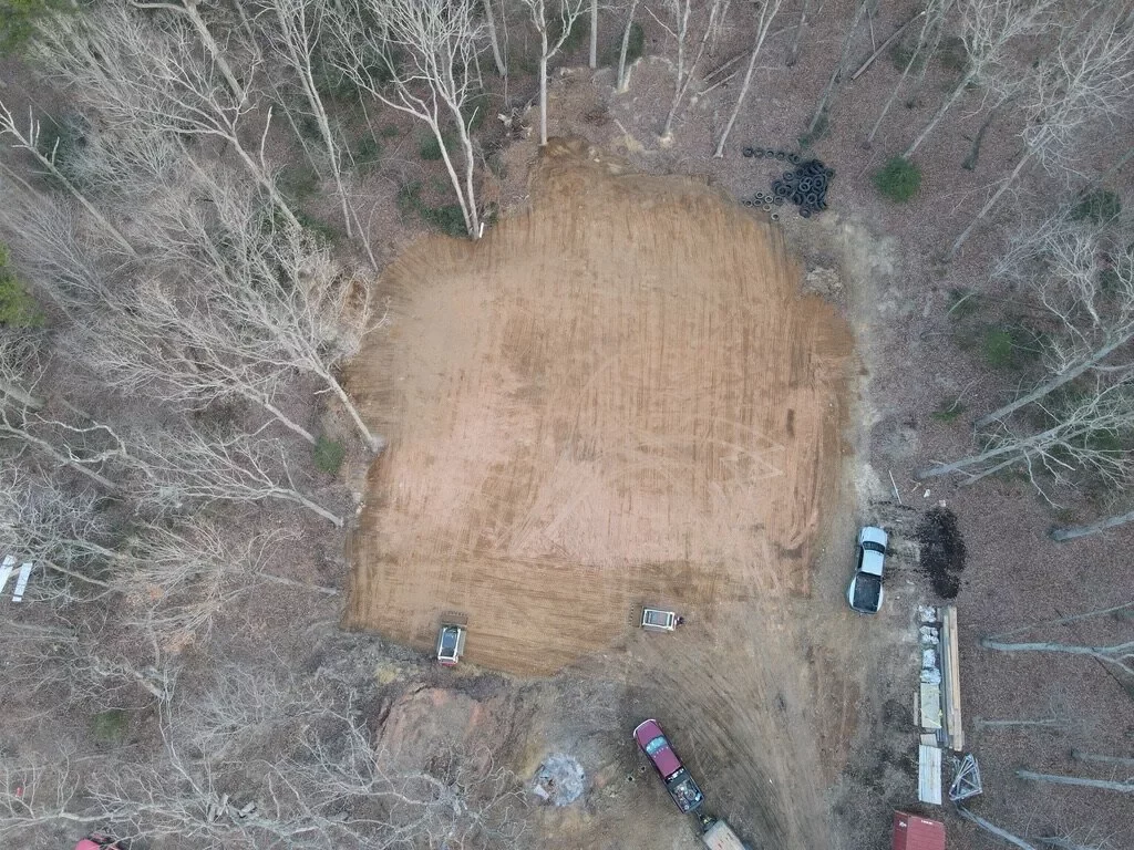Aerial view of a cleared and graded building site prepared for metal building construction