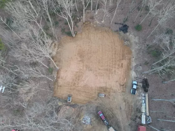 Aerial view of a cleared and graded building site prepared for metal building construction