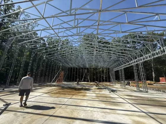 Wide-span steel-frame interior of a metal building under construction with high open clearance